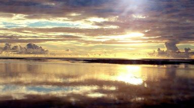 Photograph of a sunrise over the ocean